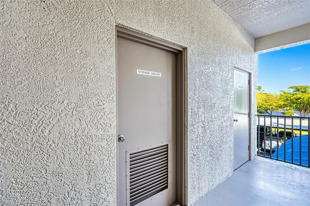 Doorway to property featuring stucco siding and a balcony