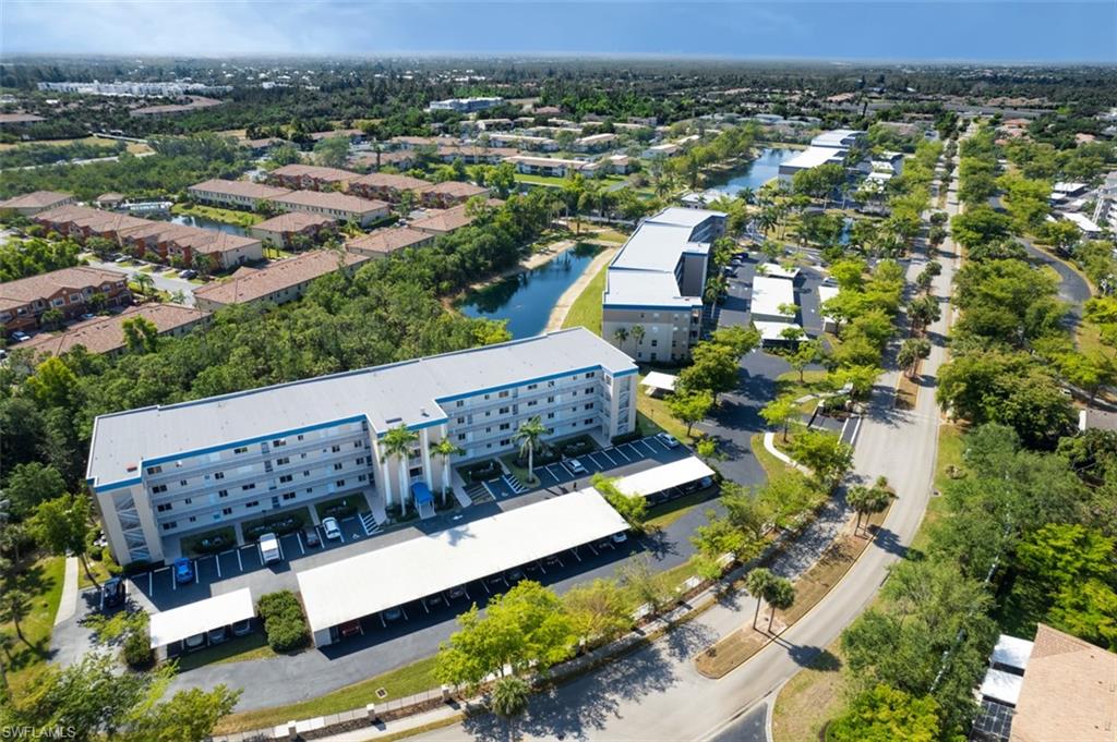 Birds eye view of property with a water view