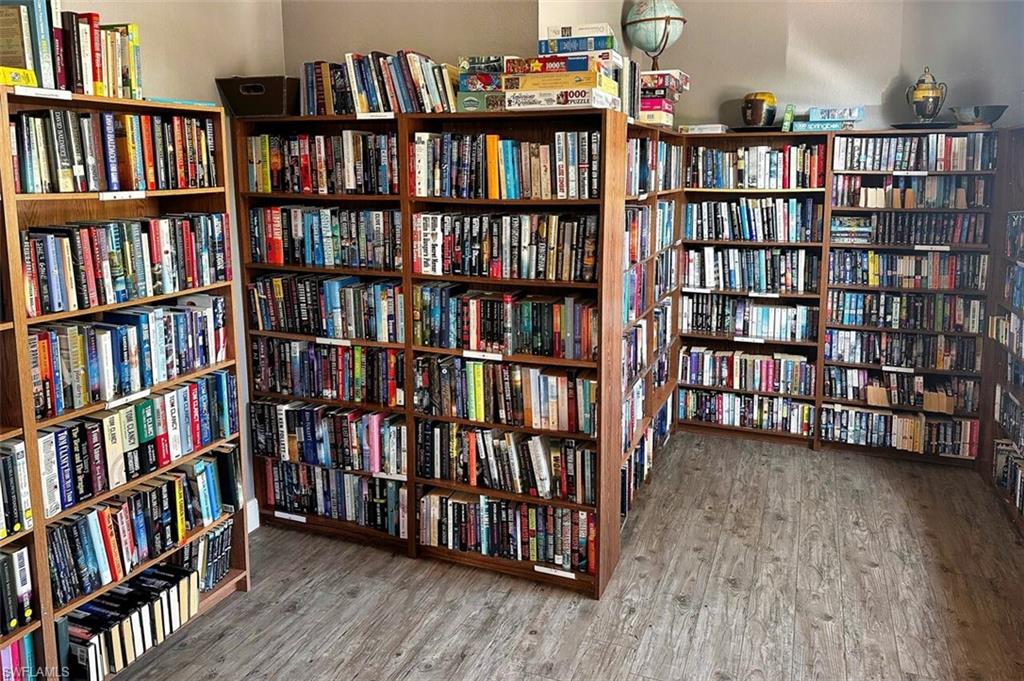 Living area featuring bookshelves and wood finished floors