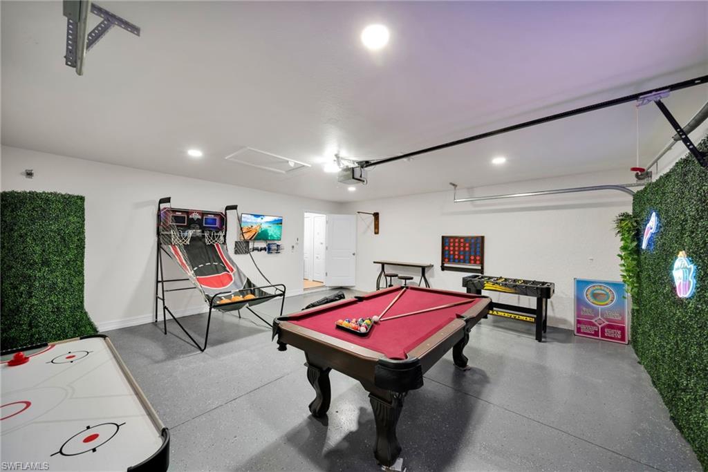 Rec room with baseboards, recessed lighting, a garage, and pool table