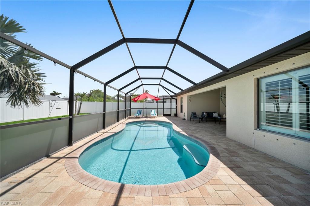 View of pool featuring a lanai, a patio, and a fenced in pool