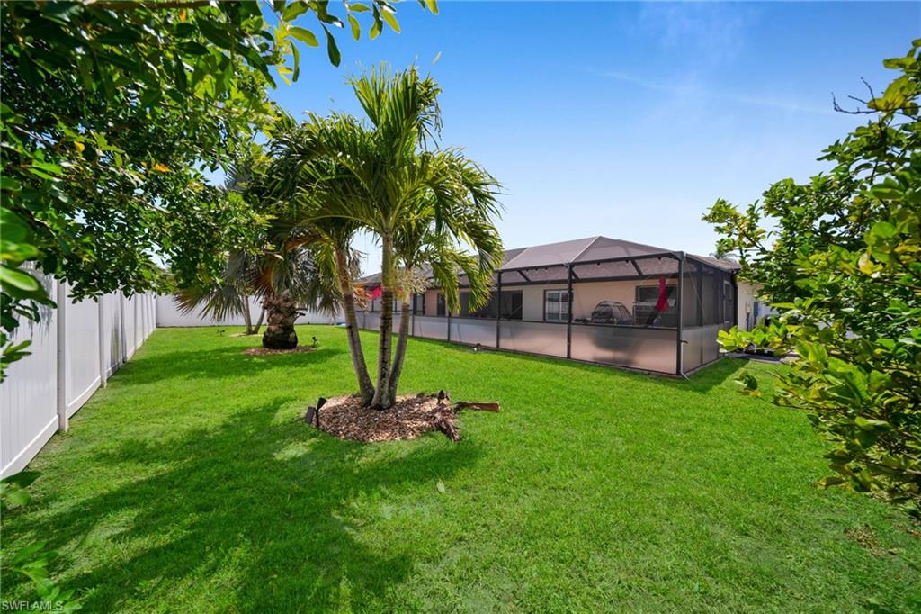 View of yard with a lanai and a fenced backyard