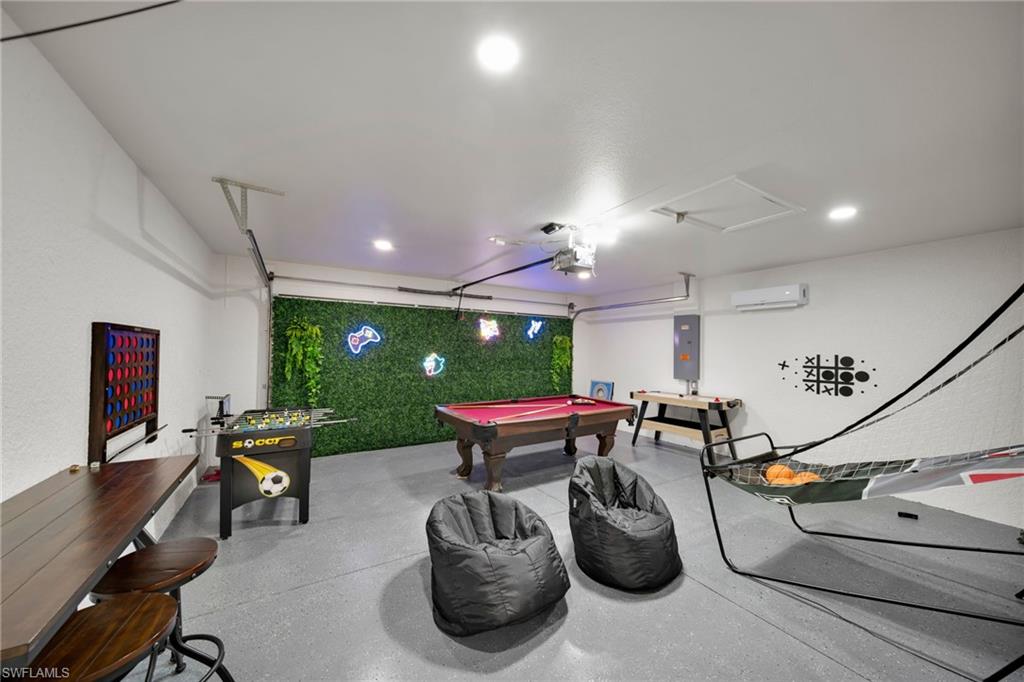 Game room with a wall unit AC, electric panel, attic access, recessed lighting, and pool table