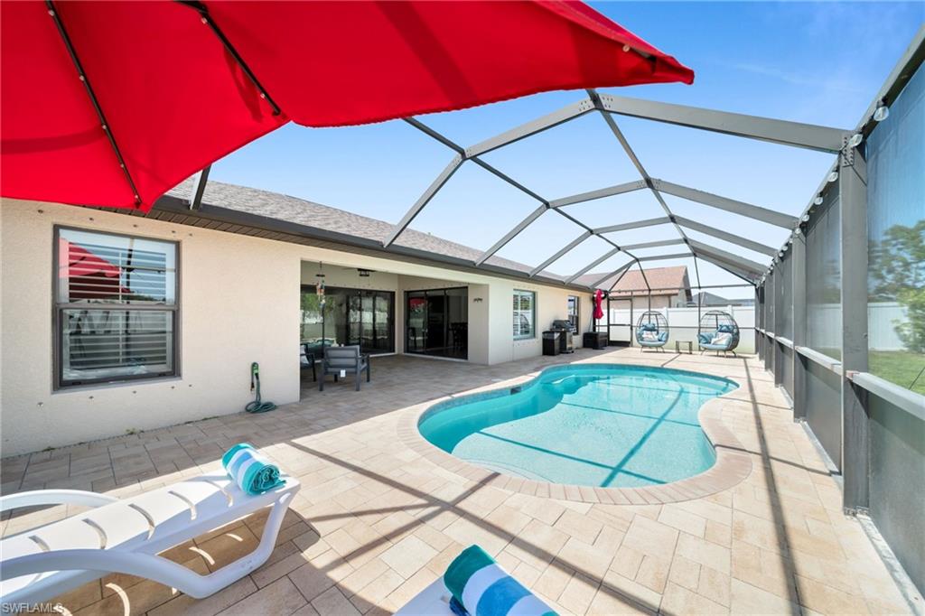 Pool featuring a patio area and glass enclosure