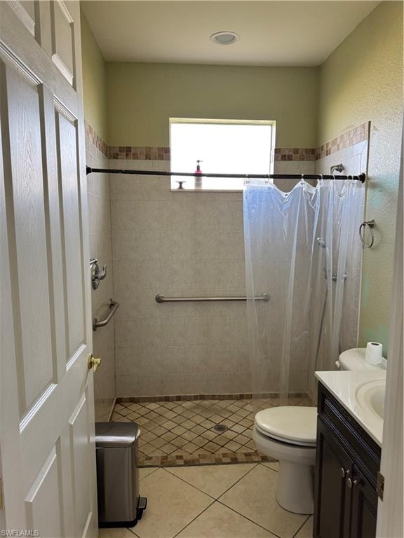 Unfurnished bedroom with dark carpet, ceiling fan, baseboards, and a closet