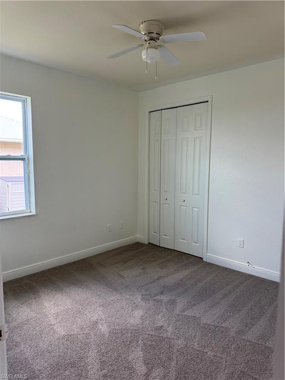 Kitchen with white cabinets, light tile patterned floors, range, and fridge