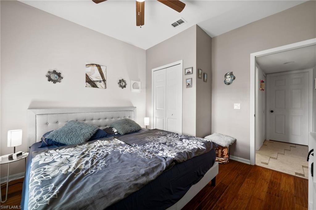 Bedroom featuring wood finished floors, baseboards, a closet, and ceiling fan