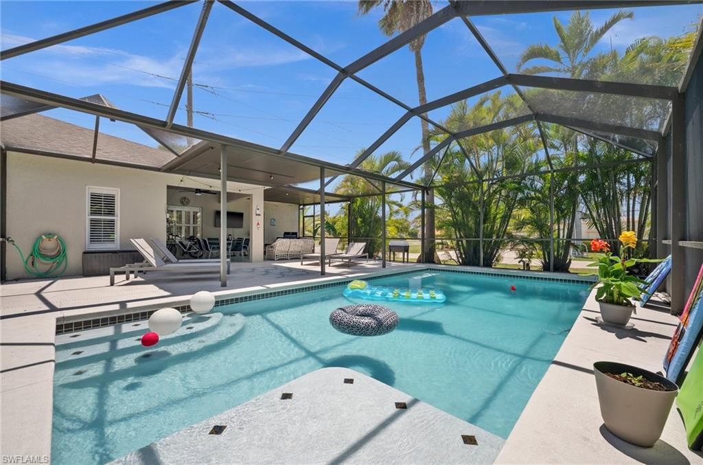Swimming pool featuring a patio area, a ceiling fan, a lanai, and an outdoor hangout area