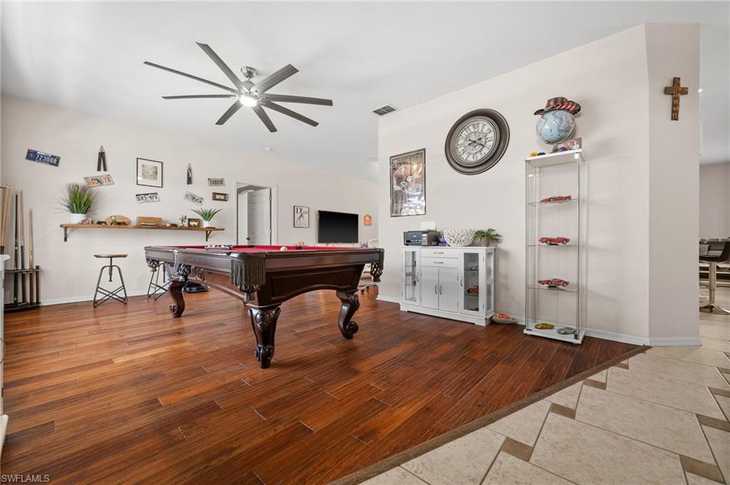 Rec room featuring ceiling fan, pool table, wood finished floors, and baseboards