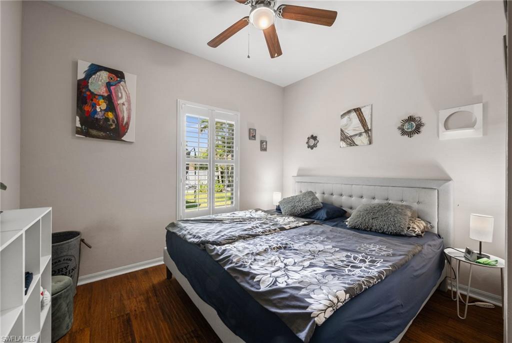 Bedroom with baseboards, wood finished floors, and ceiling fan