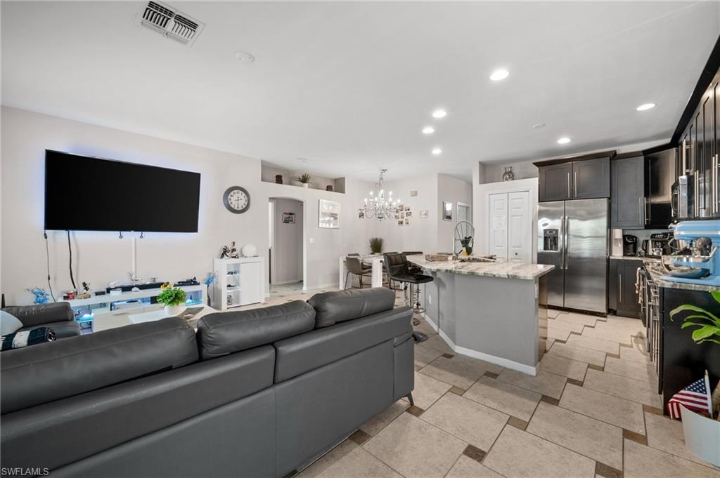 Living area featuring a chandelier and recessed lighting