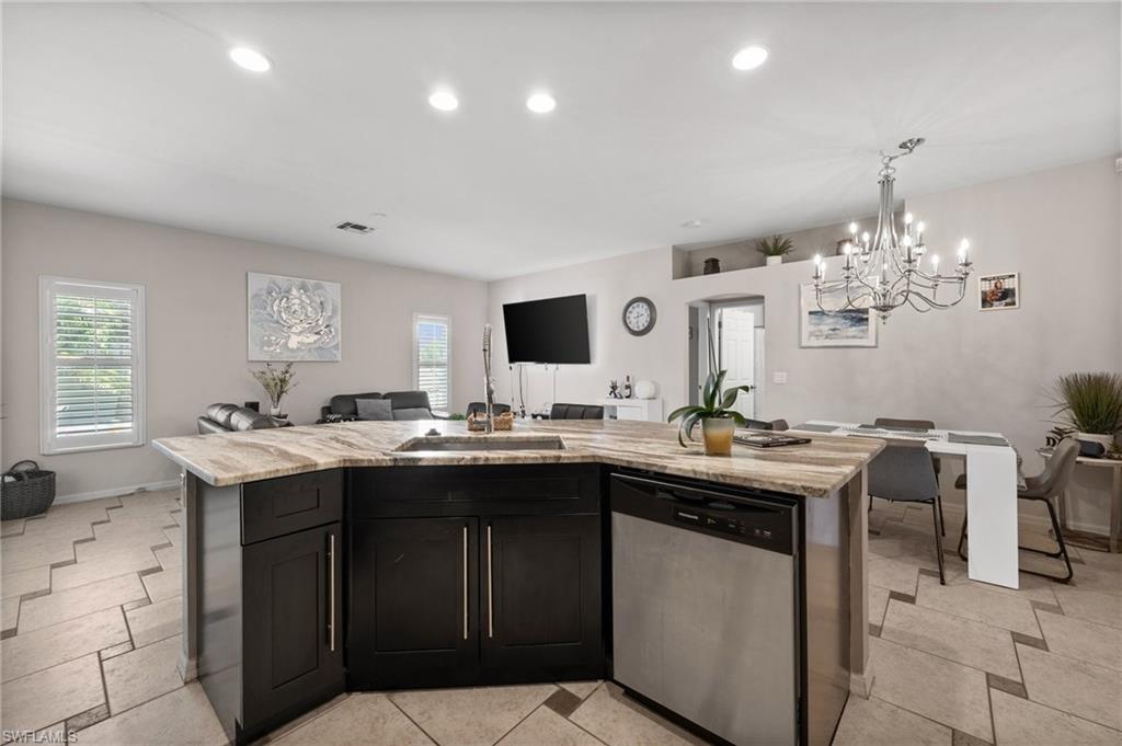 Kitchen with dishwasher, open floor plan, a chandelier, plenty of natural light, and recessed lighting