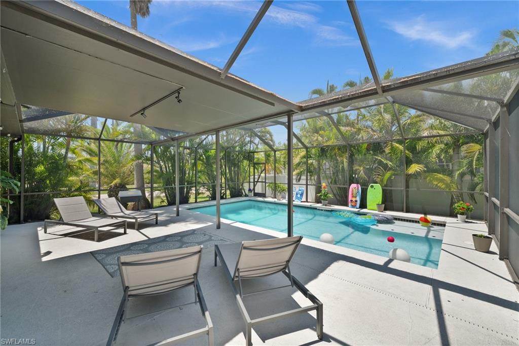 Outdoor pool with a lanai and a patio