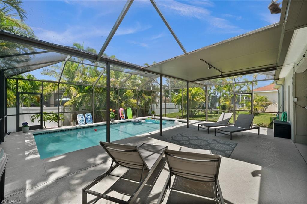 View of swimming pool with a lanai and a patio