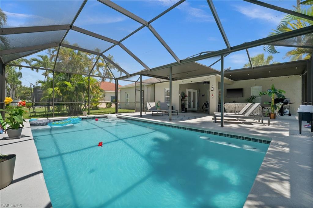 Swimming pool featuring a patio area, a lanai, and french doors
