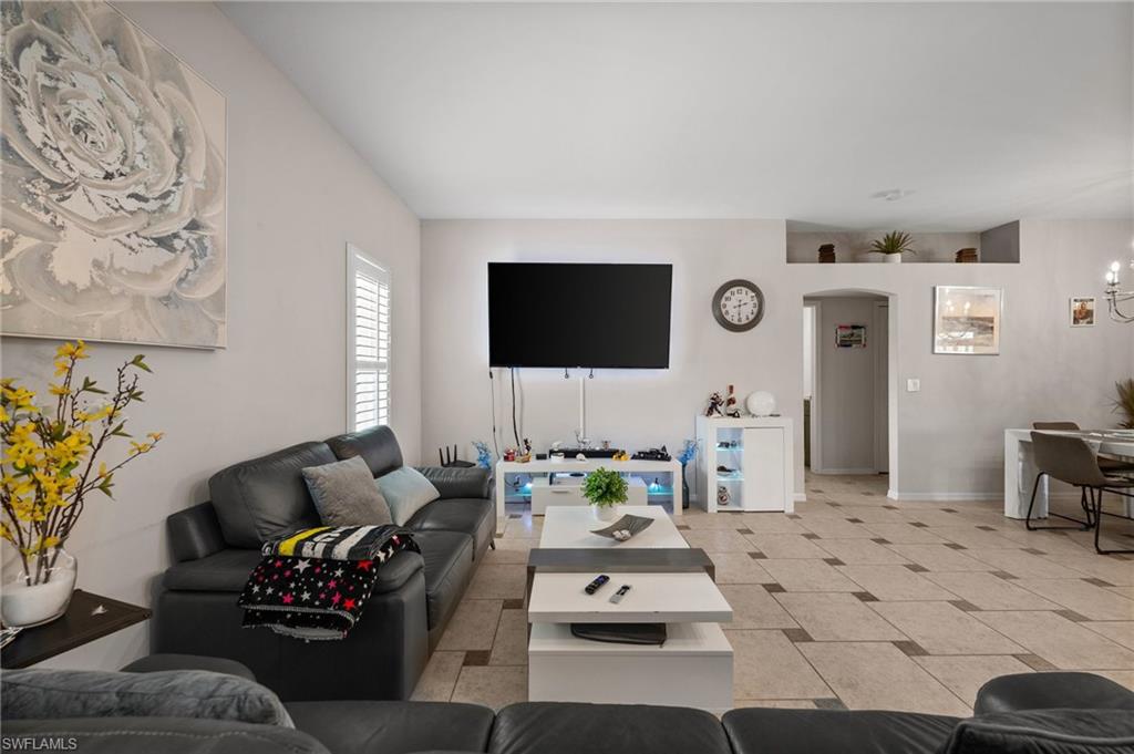 Living area featuring arched walkways and baseboards