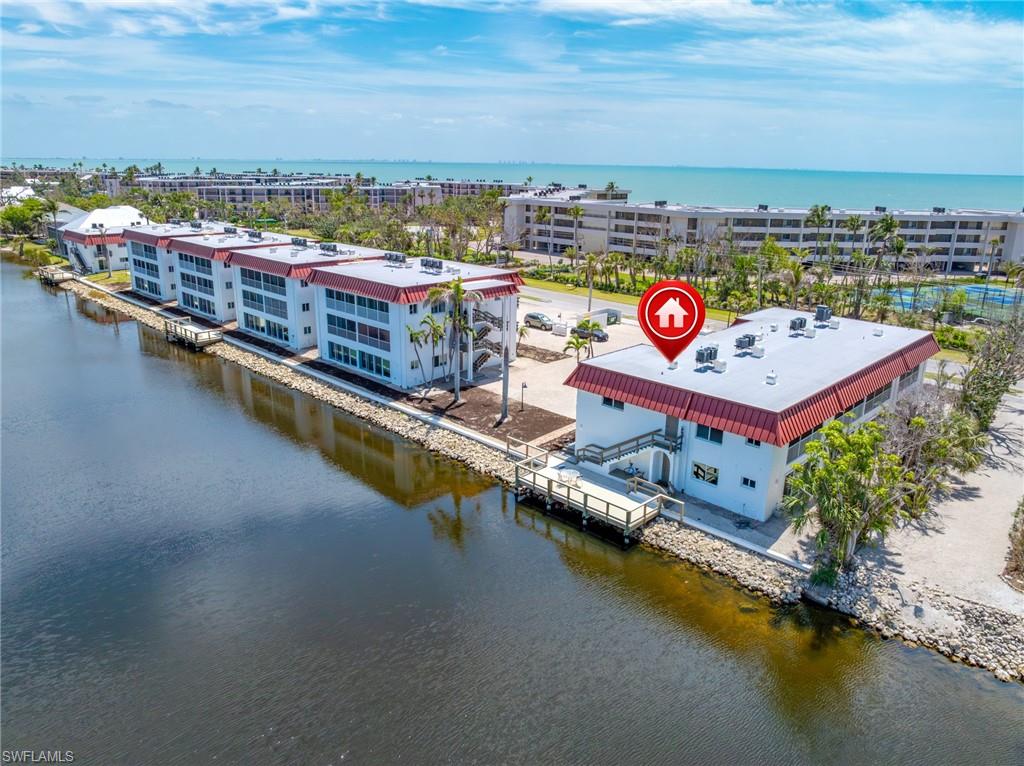 Birds eye view of property with a water view