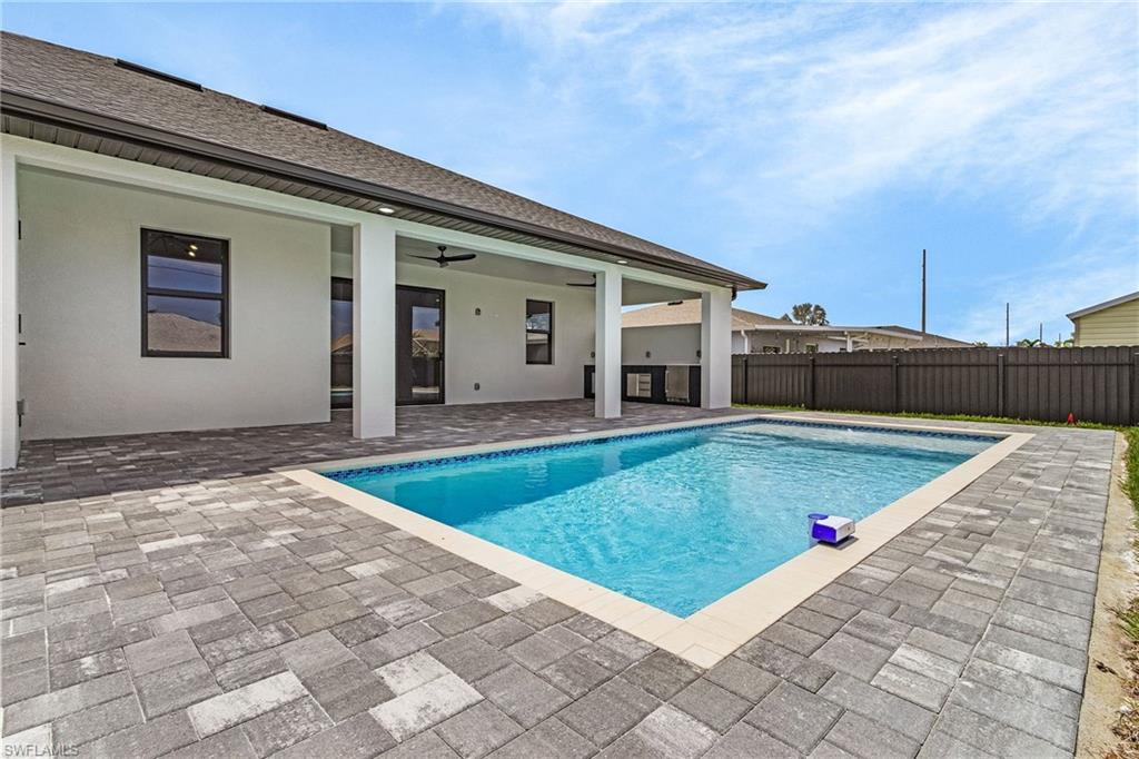 View of pool with fence and a patio area