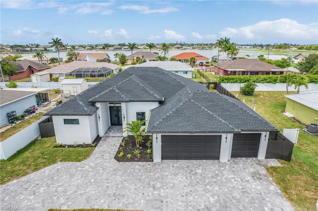 Single story home with fence private yard, decorative driveway, an attached garage, and stucco siding