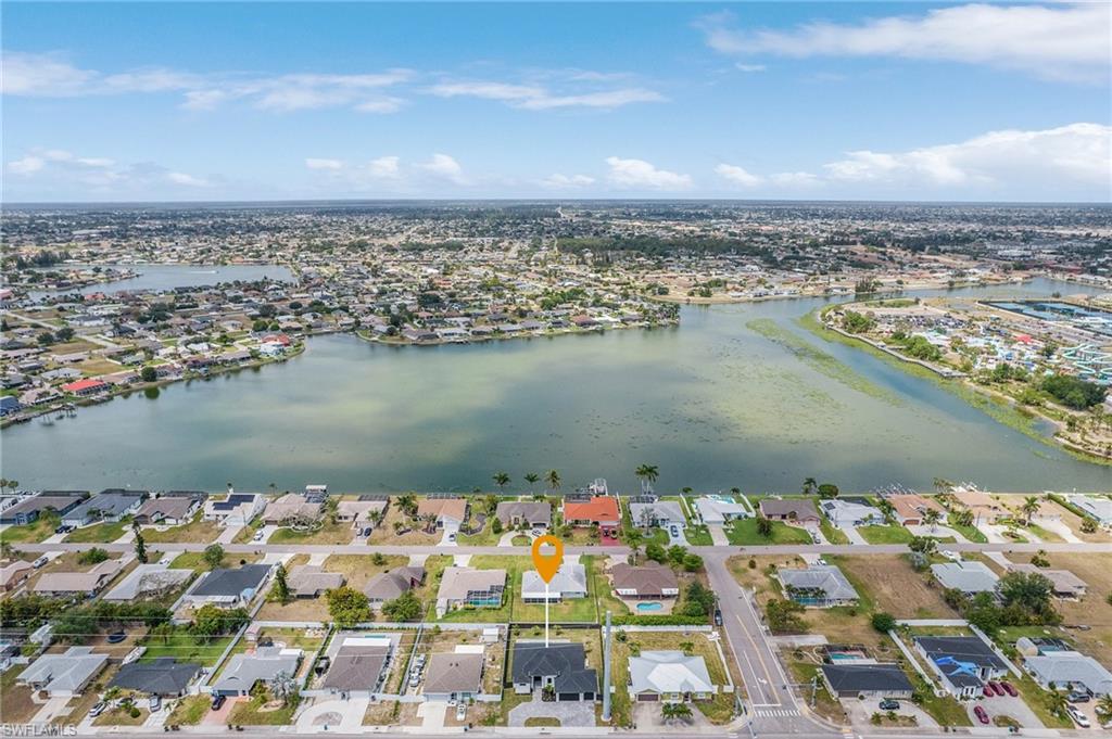 Birds eye view of property with a residential view and a water view