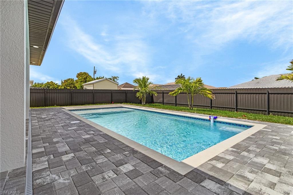 View of pool with a fenced in pool, a patio, and a fenced backyard