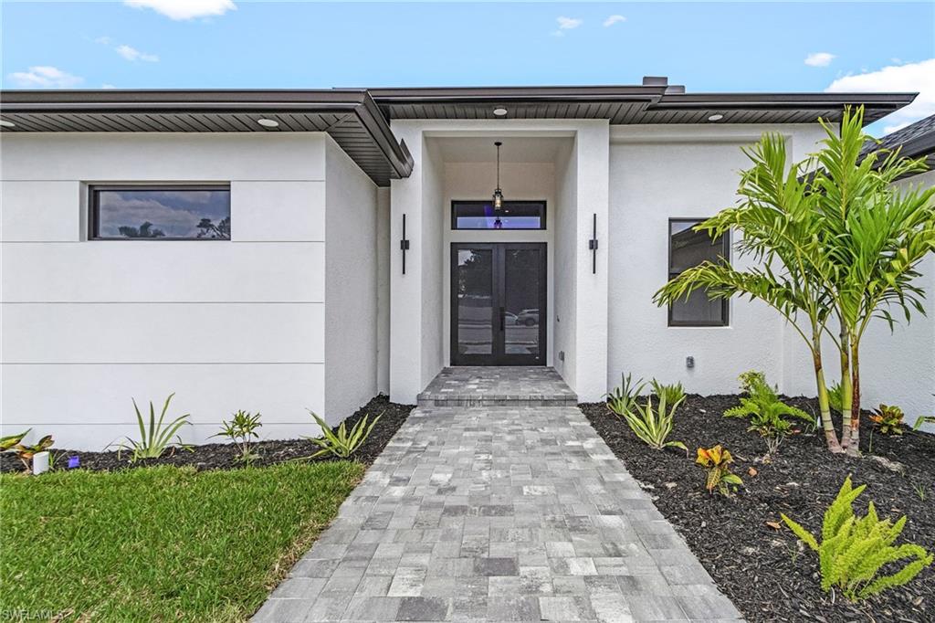 Property entrance featuring french doors and stucco siding