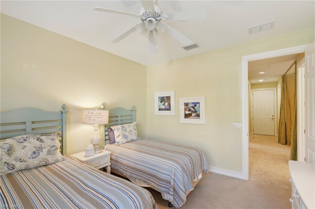 Carpeted bedroom featuring visible vents, a ceiling fan, and baseboards