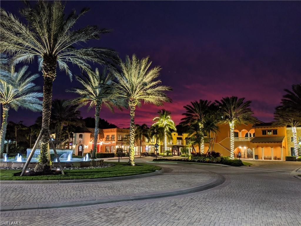 Property at night featuring curved driveway