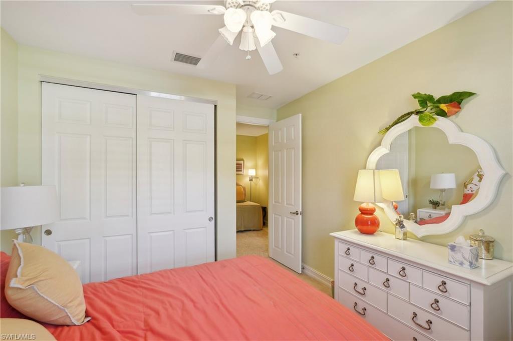 Bedroom featuring ceiling fan, visible vents, baseboards, and a closet