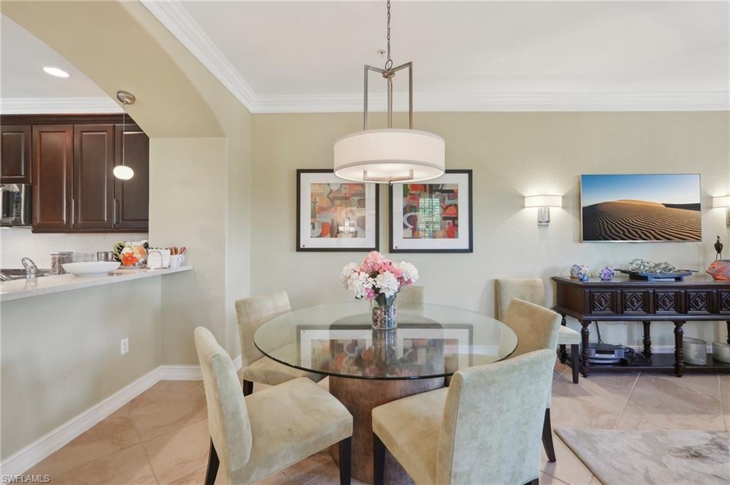 Dining space with baseboards, ornamental molding, and light tile patterned floors