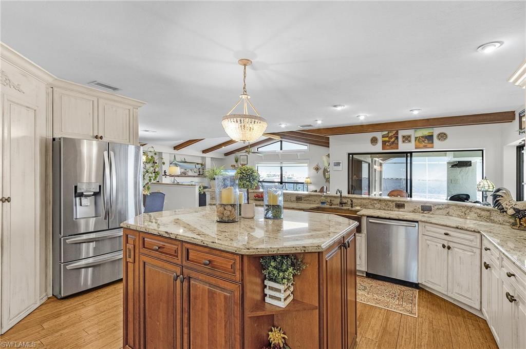 Kitchen prep island, granite counters, engineered wood durable flooring, and appliances with stainless steel finishes and huge walk in pantry