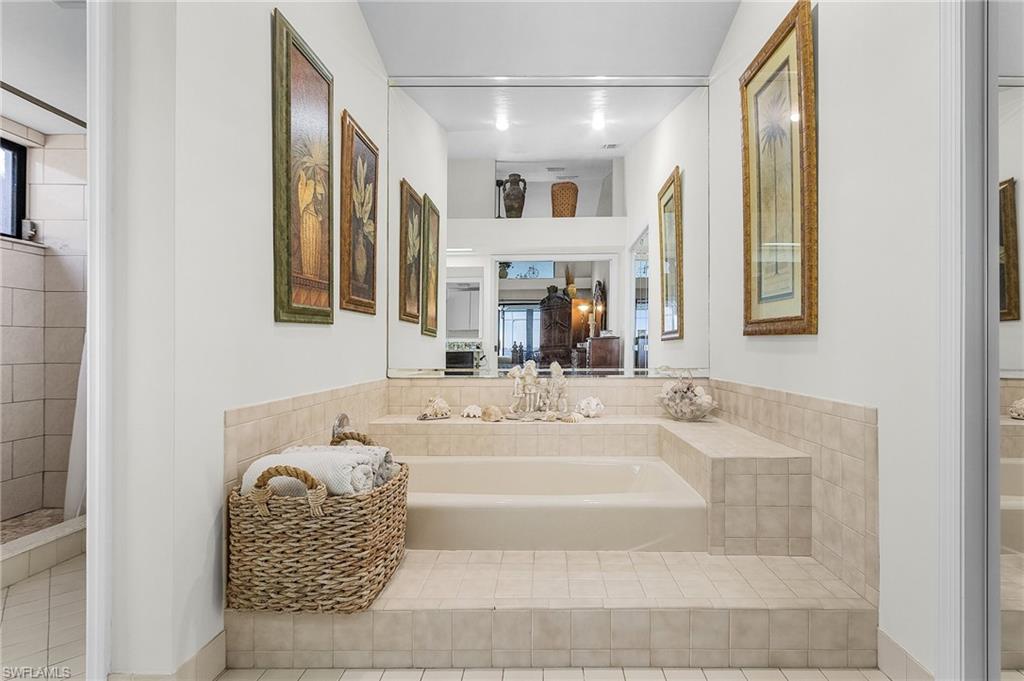 Primary ensuite Bathroom downstairs with soaking tub, water closet with walk in shower, large walk in closet