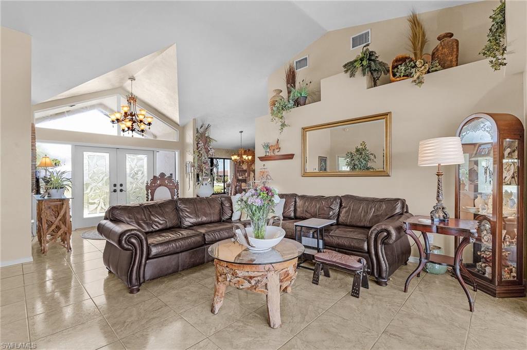 Living area with visible vents, high cathedral ceilings, french doors and endless options