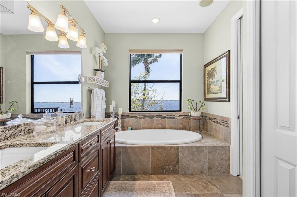 Ensuite Full bathroom upstairs featuring double vanity, , and a jetted tub and huge walk in shower and water closet, linen closet and River View