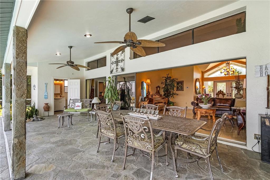 Huge under truss lanai with easy access to the entire home,  Flagstone floor, and recessed lighting, pool bath and storage