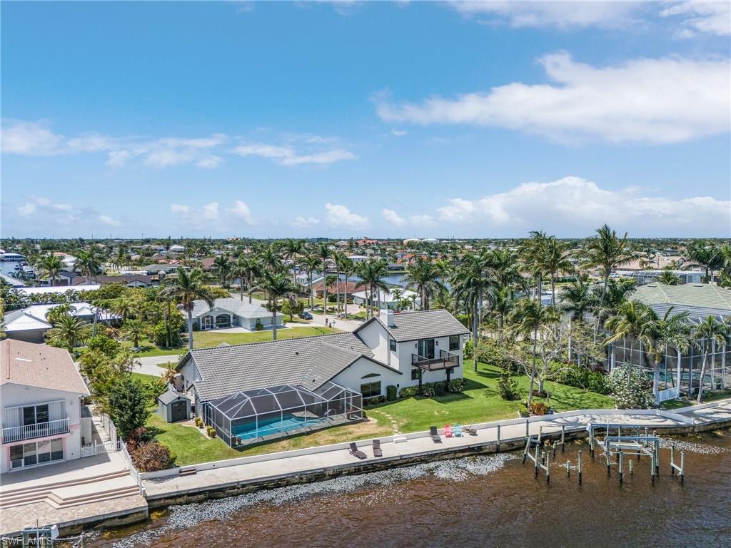 Birds eye view of property featuring a water view and a residential view