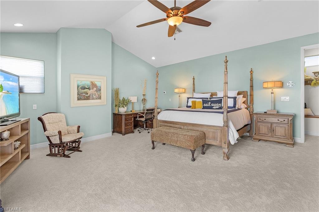 Primary upstairs Bedroom with ceiling fan, new carpet, baseboards, cathedral ceiling, and recessed lighting and Best River View