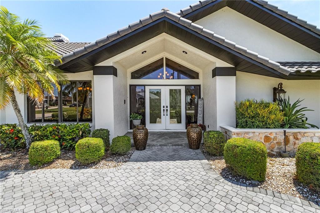 View of exterior entry featuring french doors, a tile roof, and stucco sidingWelcome Home