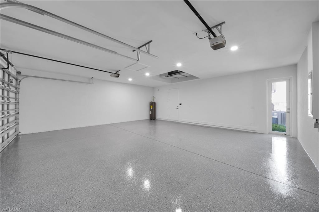 Empty room with visible vents, marble finish floor, baseboards, a sunroom, and a tray ceiling