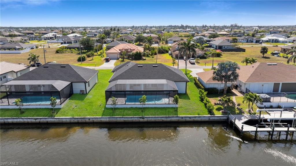 Drone / aerial view with a water view and a residential view