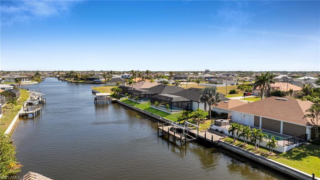 Birds eye view of property with a residential view and a water view