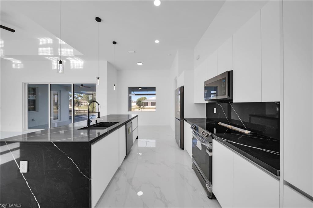 Kitchen with visible vents, modern cabinets, white cabinetry, a sink, and dishwasher
