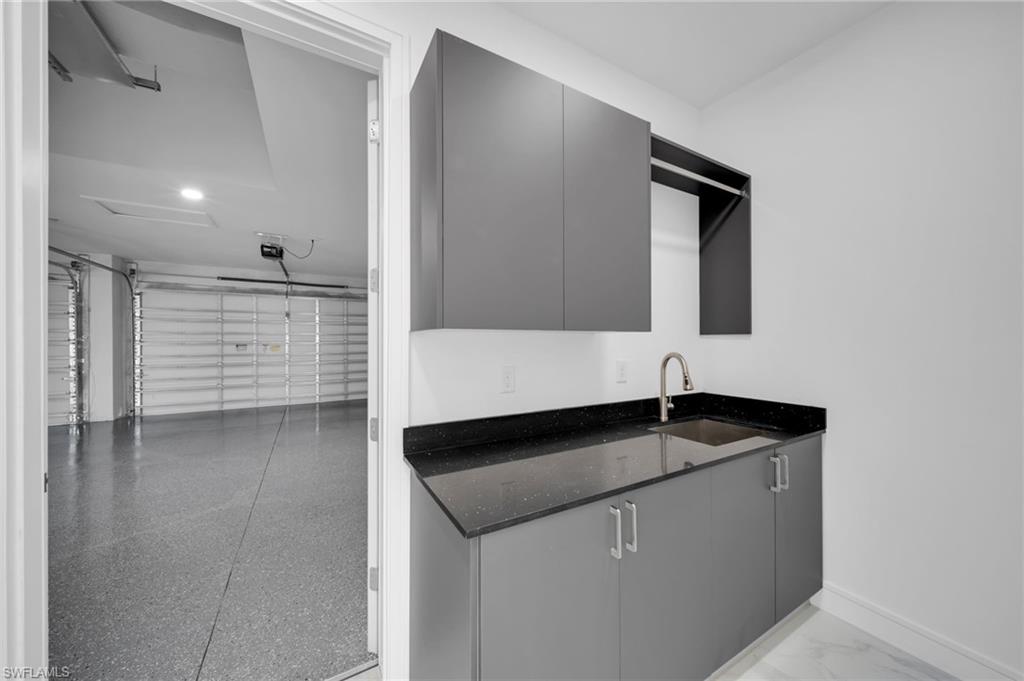 Laundry room with a garage and washing machine and clothes dryer