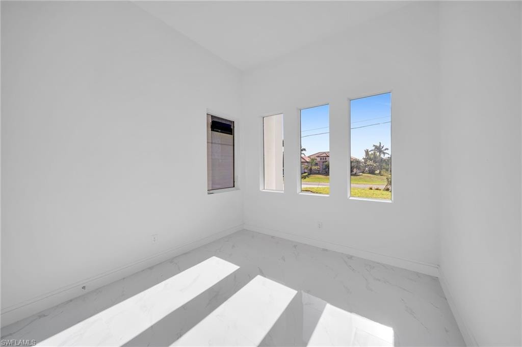 Spare room with baseboards, visible vents, and marble finish floor