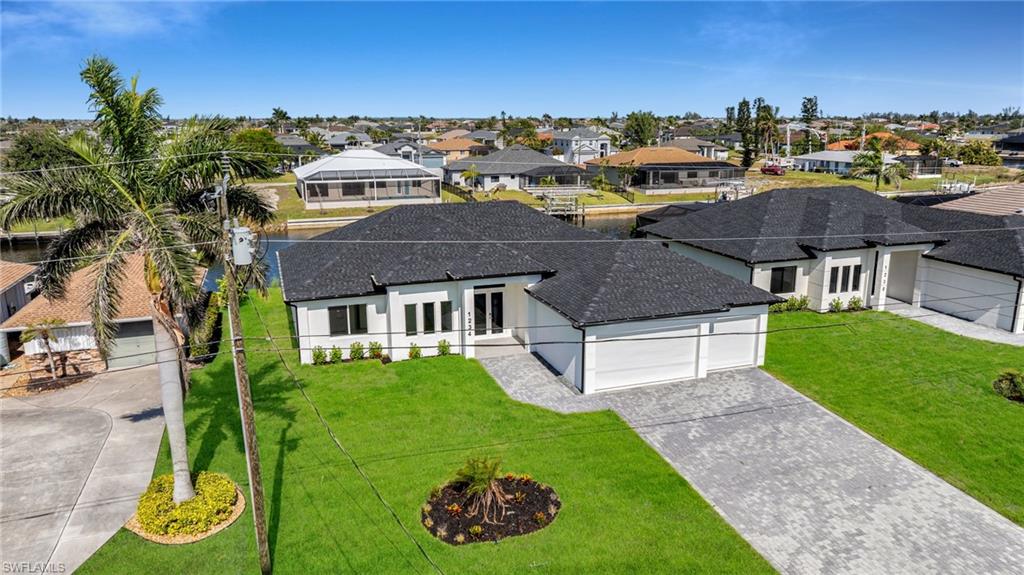 Birds eye view of property featuring a residential view and a water view