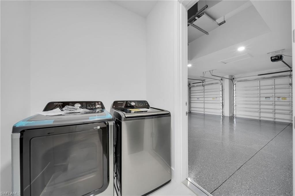 Garage featuring a garage door opener, electric panel, and recessed lighting