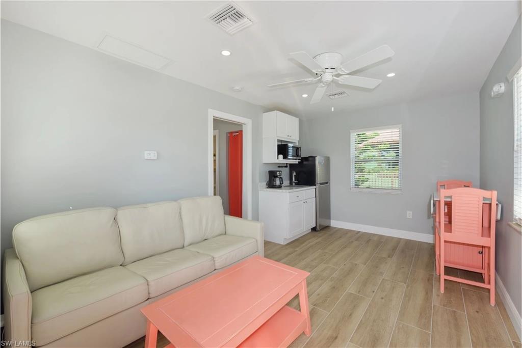 Spacious living area with ample natural light, perfect for entertaining or relaxing (Beach home 2) - Virtually Edited Image