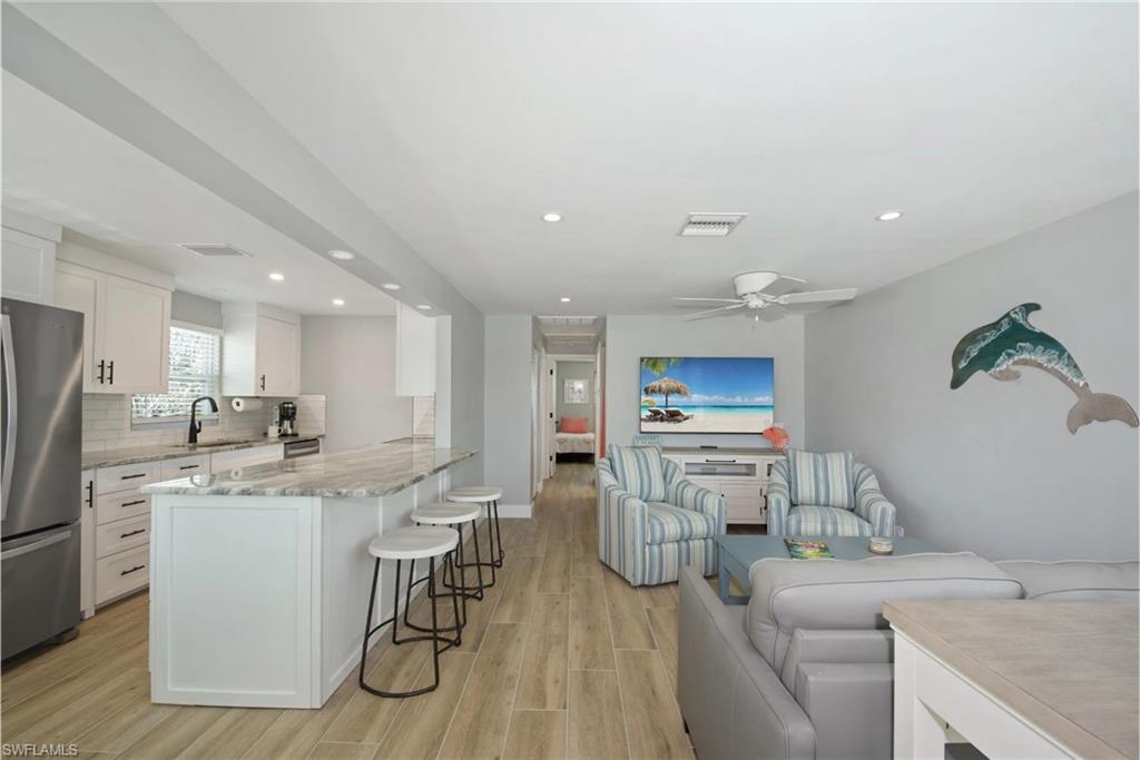 Well-equipped kitchen featuring modern cabinetry and ample counter space (Beach home 1)  - Virtually Edited Image