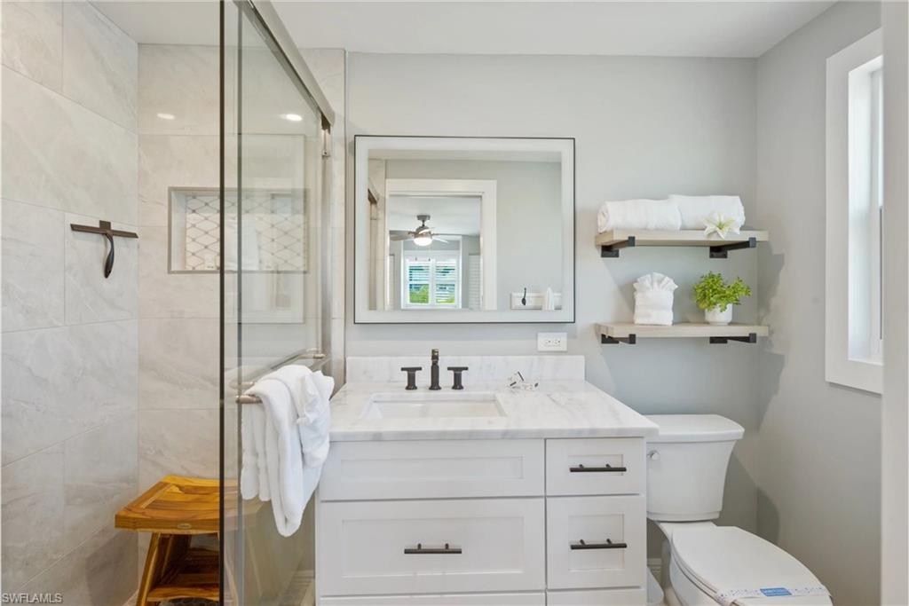Stylish bathroom with elegant tile work and ample storage space (Beach home 1) - Virtually Edited Image