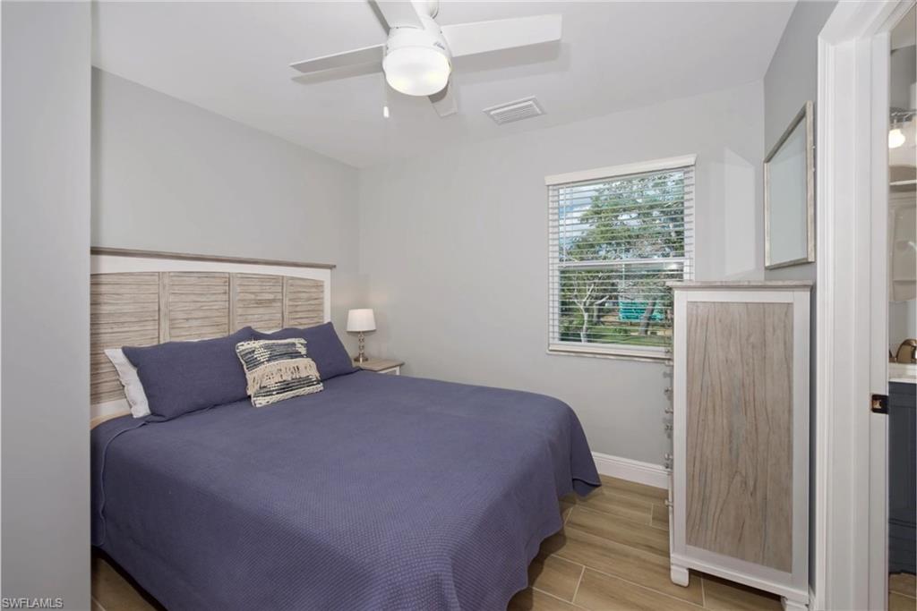 Relaxing bedroom retreat featuring a king-sized bed and a peaceful atmosphere (Beach home 2) - Virtually Edited Image